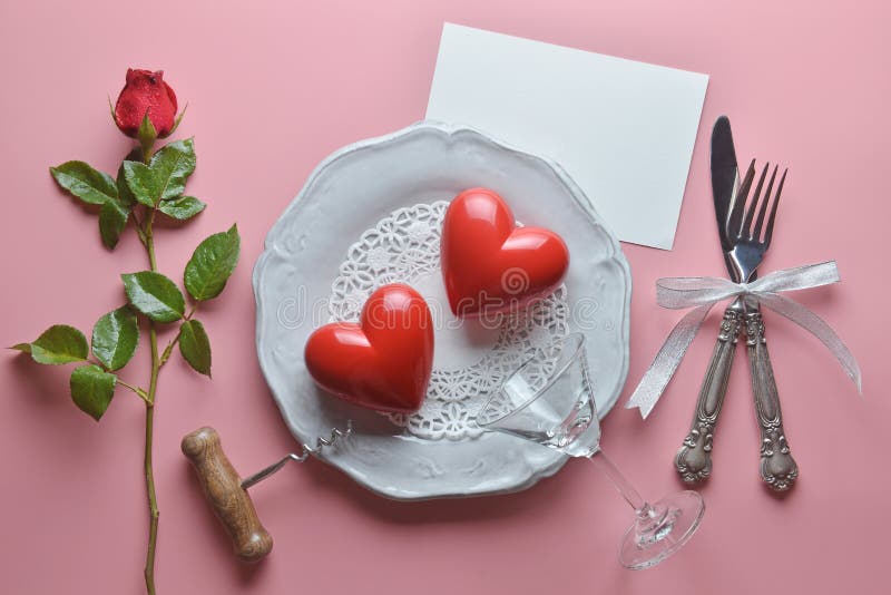 Red couple heart, wine opener, cocktail glass on white dish, with fork and knife in ribbon, Rose , On pink background. royalty free stock images Red couple heart, wine opener, cocktail glass on white dish, with fork and knife in ribbon, Rose , On pink background. royalty free stock images
