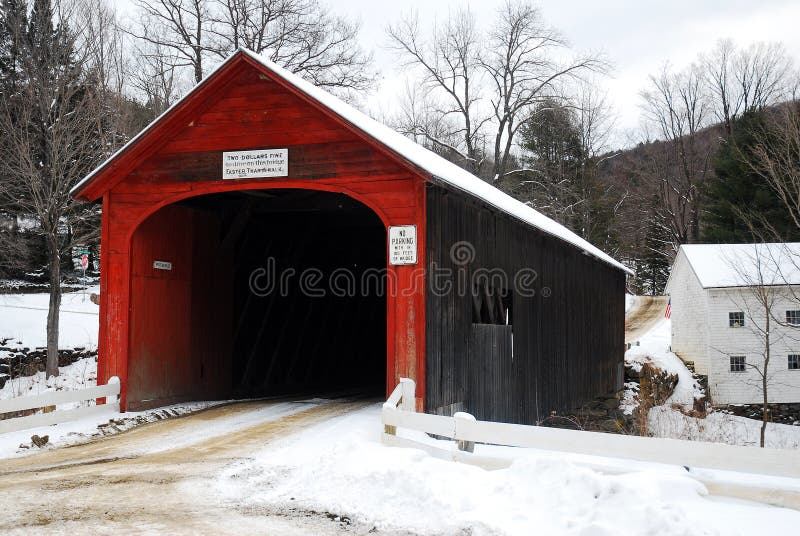 A red covered bridge in the Vermont winter