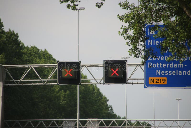 Red crosses above closed driving lanes on Highway A20 at Nieuwerkerk aan den IJssel, closed for maintenance. stock photo Red crosses above closed driving lanes on Highway A20 at Nieuwerkerk aan den IJssel, closed for maintenance. stock photo