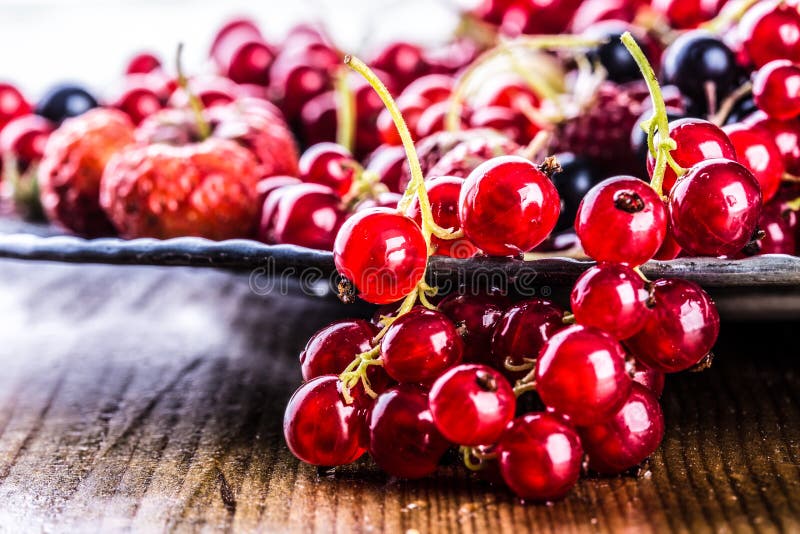 Red currant sponge cake. Plate with Assorted summer berries, raspberries, strawberries, cherries, currants, gooseberries.