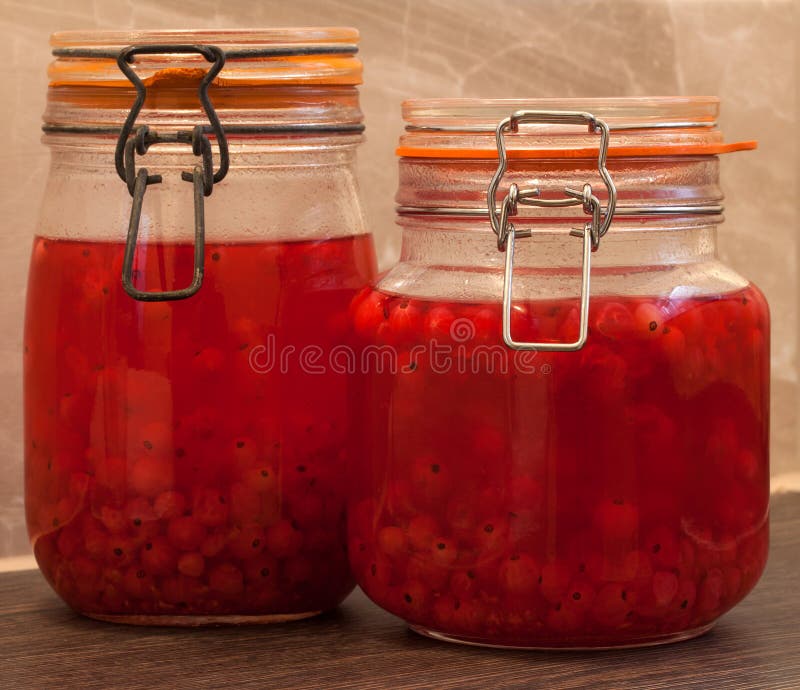 Home made red current gin in preserve jars. stock photography