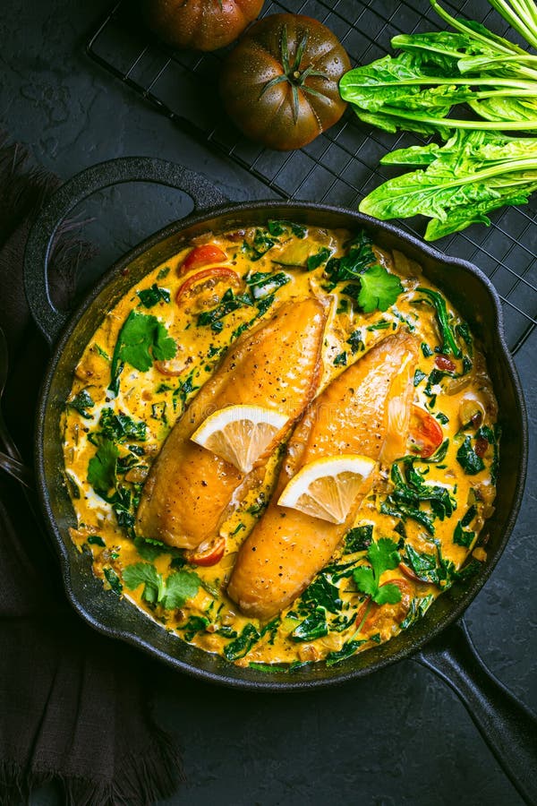 Red Curry with Spinach, Coconut Milk and Baked Fish Stock Image - Image