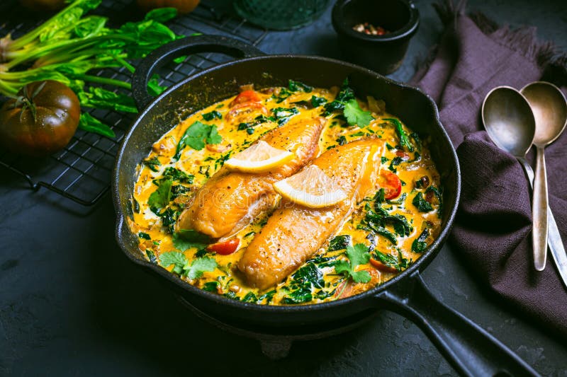 Red Curry with Spinach, Coconut Milk and Baked Fish Stock Photo - Image
