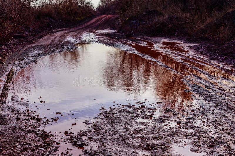 Red Dirt Road Polluted with the Iron Ore. Environmental Pollution Stock