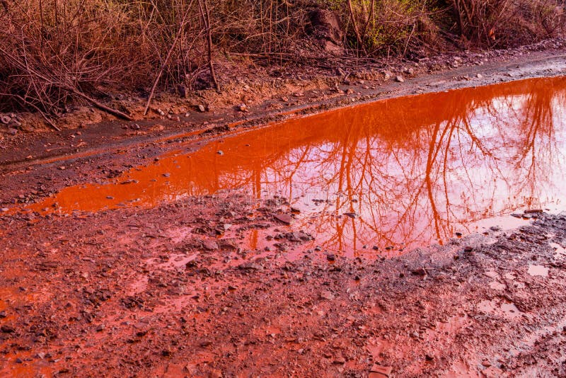 Red Dirt Road Polluted with the Iron Ore. Environmental Pollution Stock