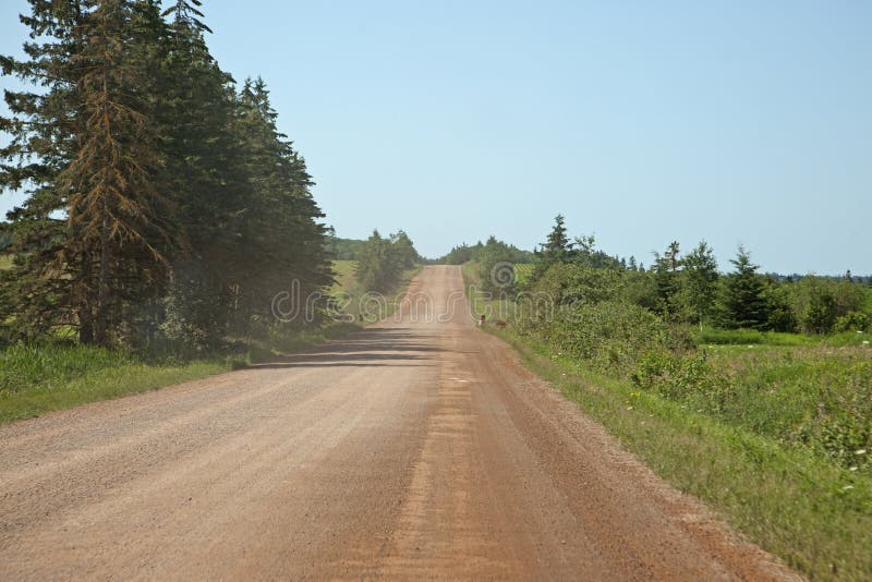 Red dirt roads of PEI stock image. Image of slope, green 154832565