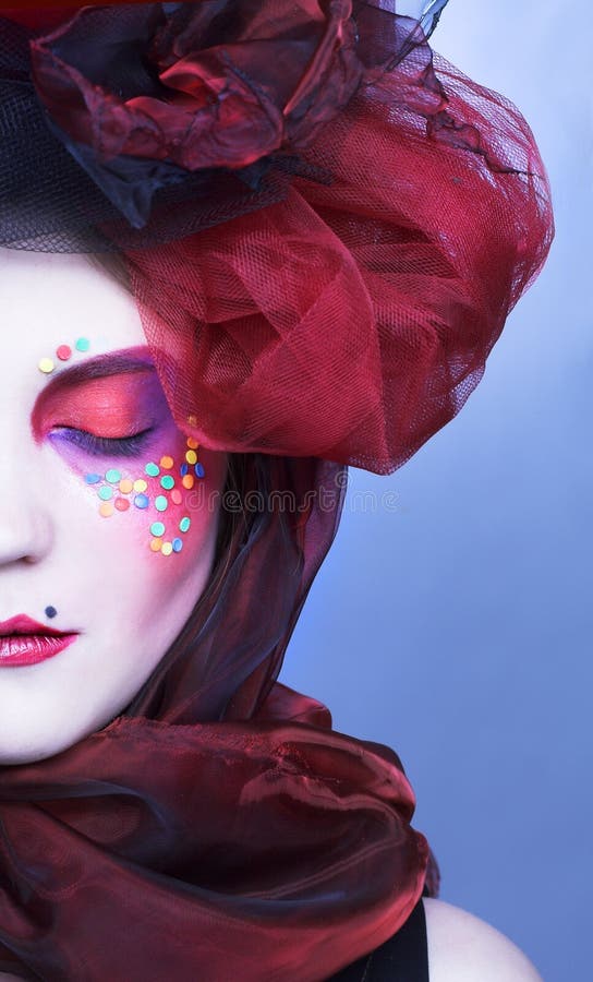 Young lady in origanal hat with creative make-up in doll-style. Bright red hat stock images, royalty-free photos and pictures