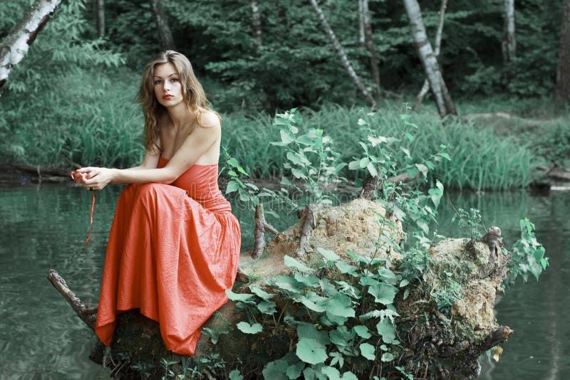 Red dressed lady on the green bank