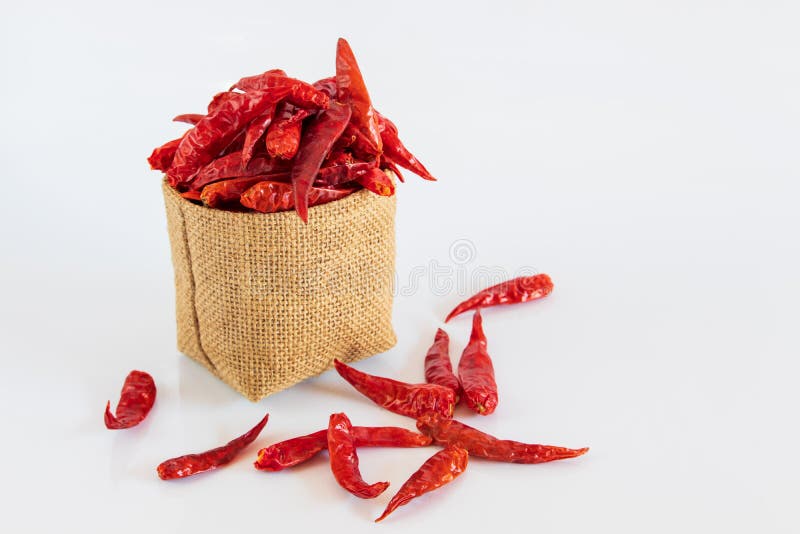 Red Dried Chili Pepper in Brown Bag on White Background Stock Photo