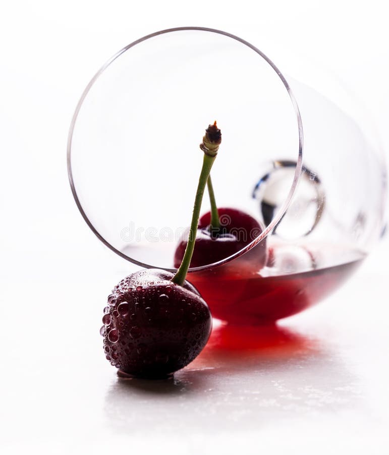 Red drink and ripe cherry berries royalty free stock image