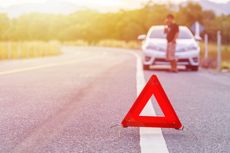 Emergency Stop Sign and Broken Silver Car on the Road Stock Image