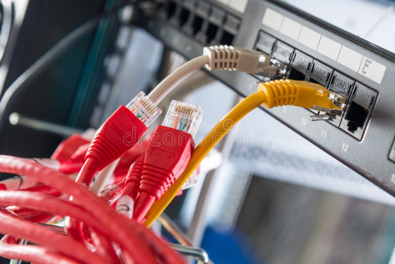 Red ethernet cables to be connected to switch stock photography