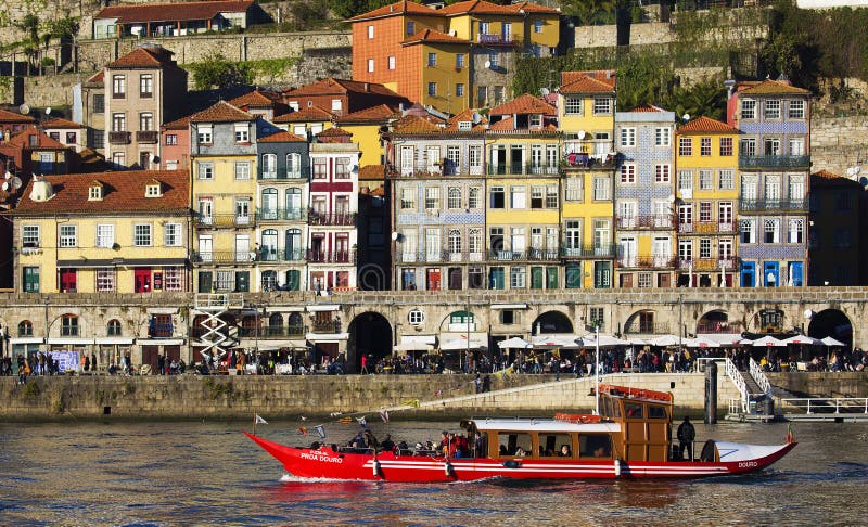 Red ferry and houses in Porto