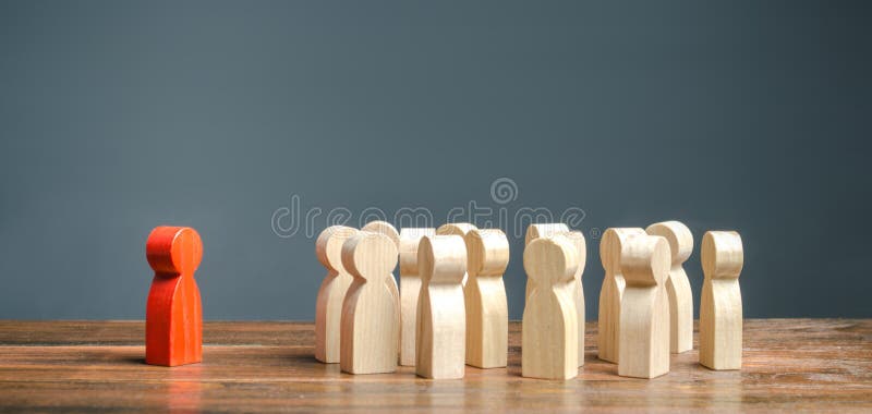 red figurine of a man stands aside from the crowd of people. Asociality, sociopathy. Rejected from society, lonely. Development stock photography red figurine of a man stands aside from the crowd of people. Asociality, sociopathy. Rejected from society, lonely. Development stock photography