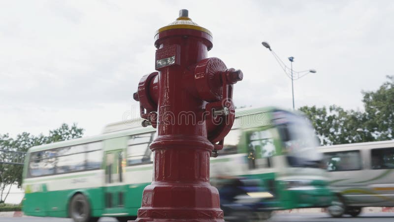 Red fire hydrant poles on street Ho Chi Minh city. Next to the road and passing cars and motorcycles. Vietnam. stock photos Red fire hydrant poles on street Ho Chi Minh city. Next to the road and passing cars and motorcycles. Vietnam. stock photos