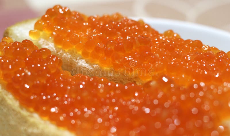 Red fish caviar on bread. enjoy your meal