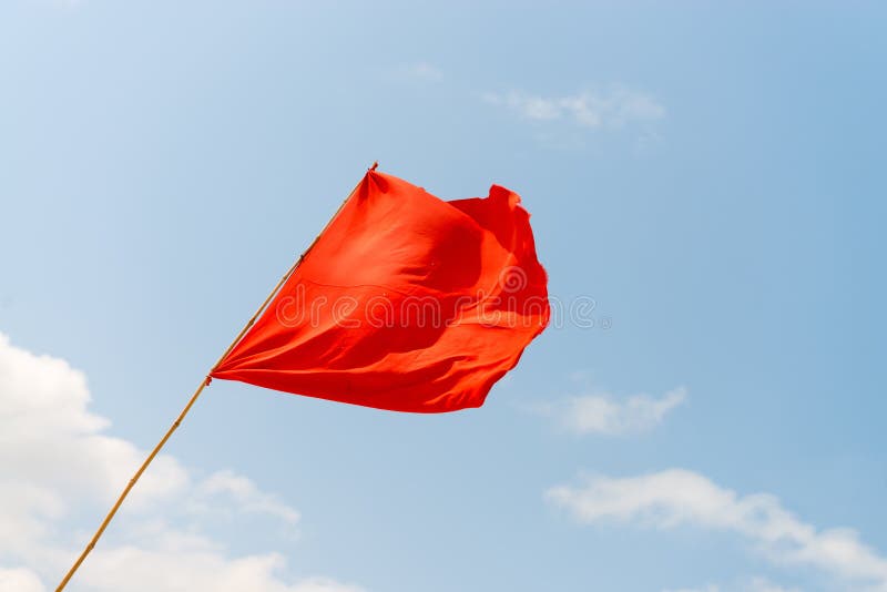 Red flag on the beach. Warning about the dangers