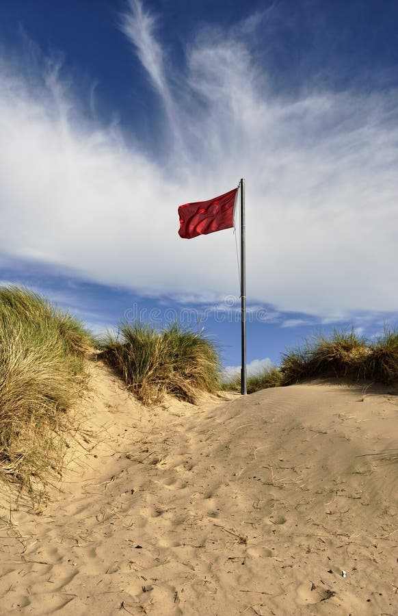 Red Flag on sand dune stock image. Image of flag, warning 15844857