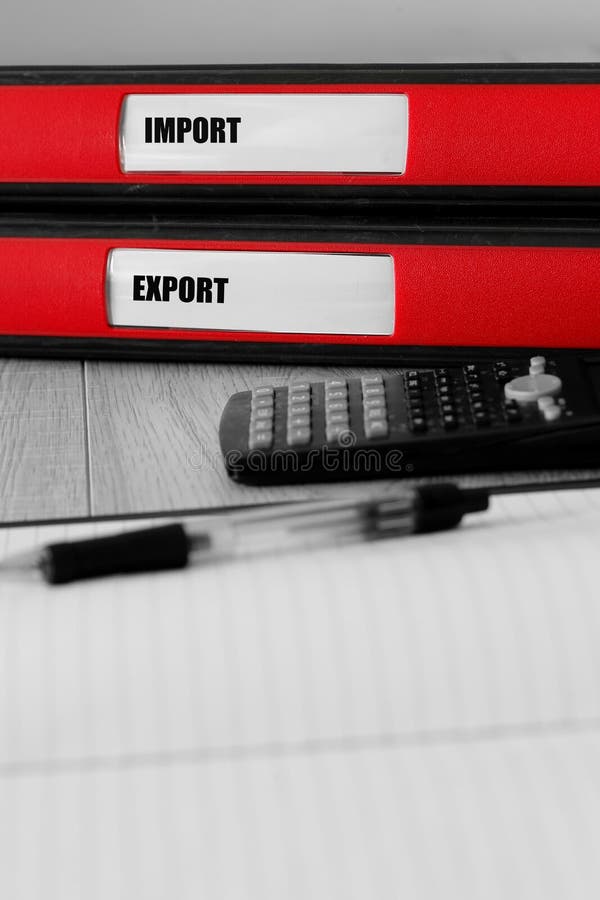 Red folders with import and export written on the label on a desk