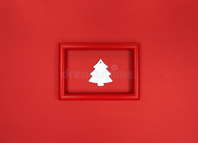 Red frame, with white wood Christmas tree toy inside stock images