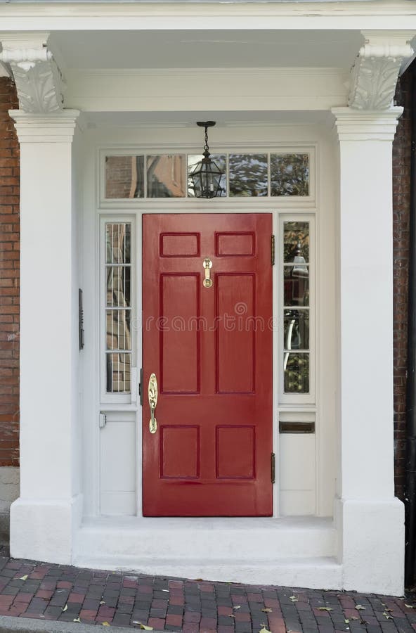 Red Front Door with White Door Frame and Windows on Brick Street stock image Red Front Door with White Door Frame and Windows on Brick Street stock image