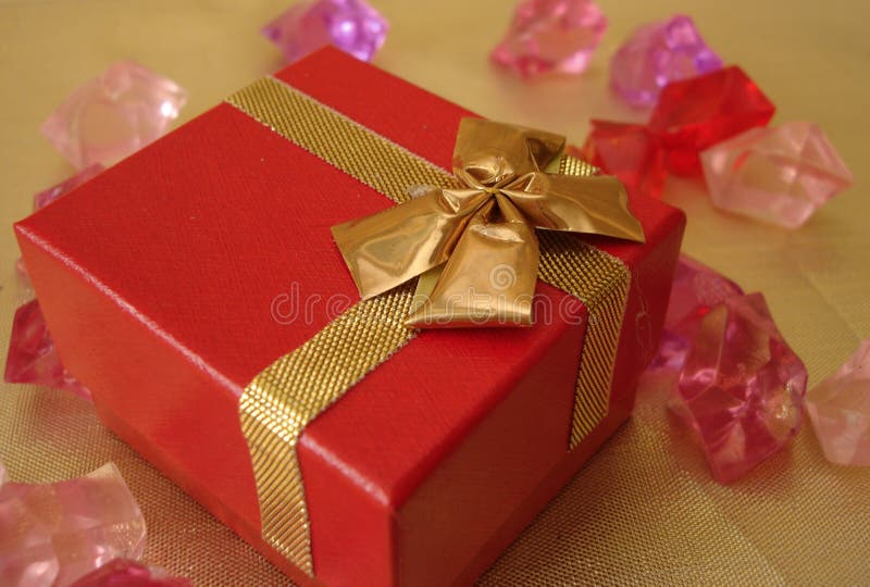 Red gift box on a beautiful golden background