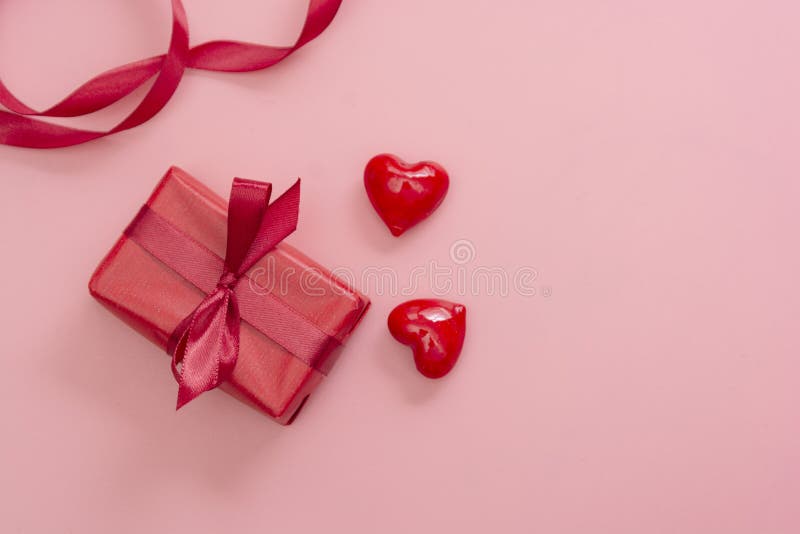 Red gift box on pink background isolated. Valentine&x27;s day mock up with copy space