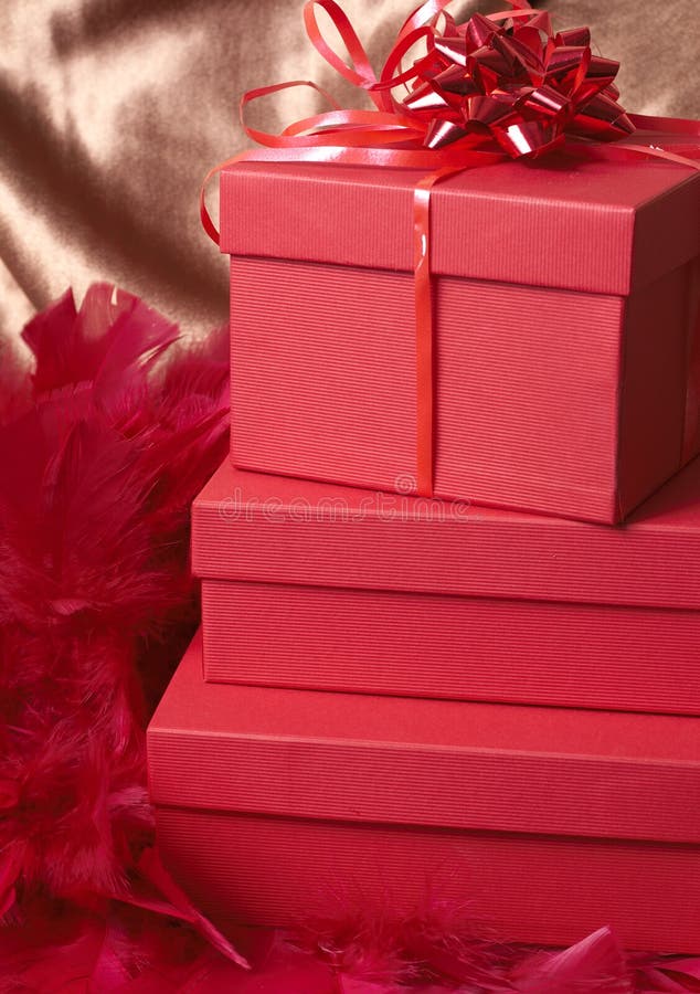 Red gift boxes with feathers and a bow