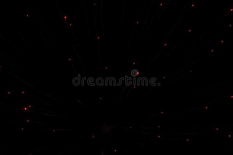 Red Glowing Lights Points from Fireworks in the Night Black Sky Stock