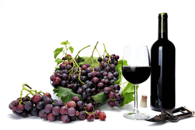 Red grape bunches and wine glass on white background.