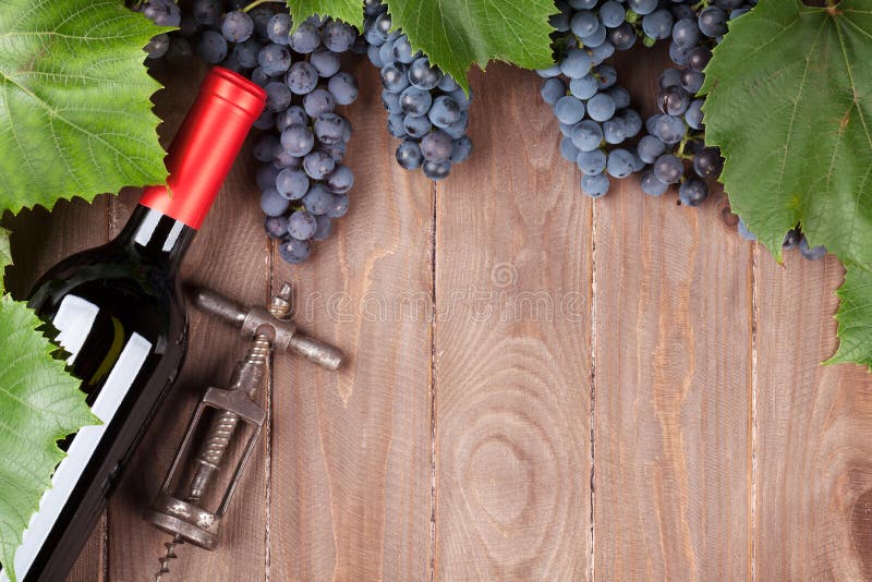 Red grape, wine bottle and corkscrew