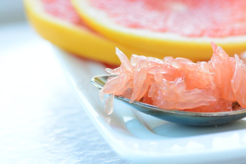 Grapefruit pulp on a spoon stock photo. Image of table 111715214
