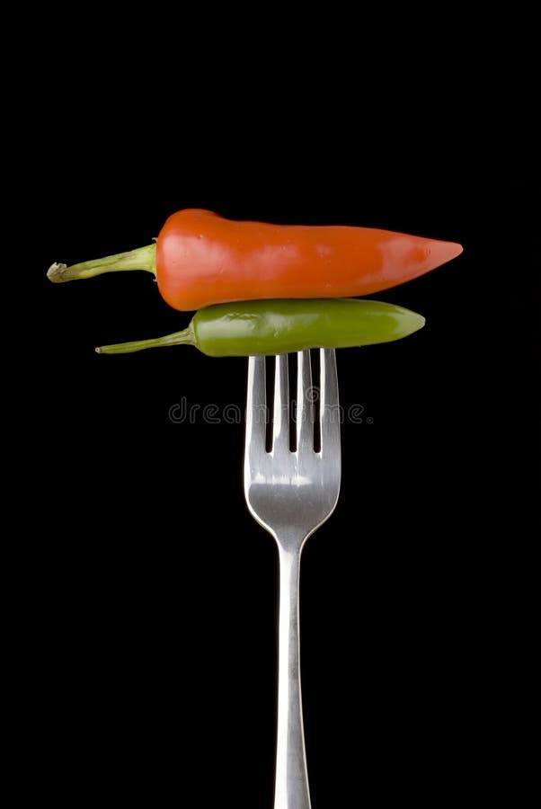 Red and green peppers on a silver fork
