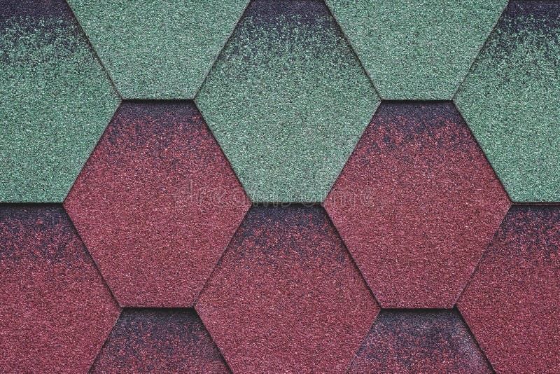 Red and green surface of roofing tiles. Cover of shape of rhombus. Dark roof tile, grunge background. Abstract mosaic of bricks ba