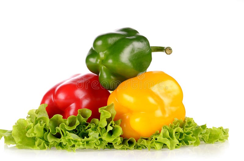 Red Green and Yellow peppers on salad leaf isolated