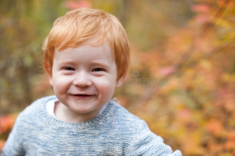 Red-haired boy is smiling cute