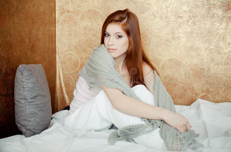 Red-haired girl on bed