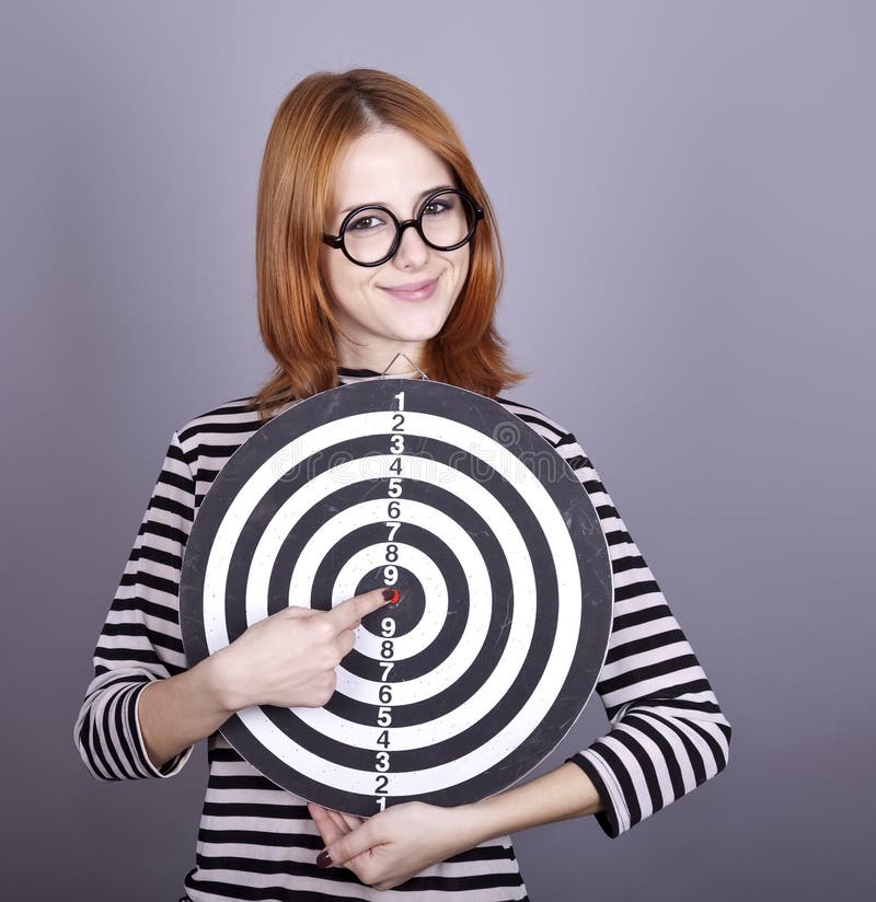 Red-haired girl with dartboard.