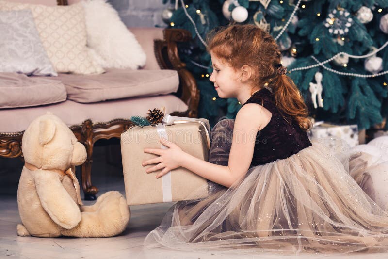Red Haired Girl Gives Christmas T To Teddy Bear Stock Image Image