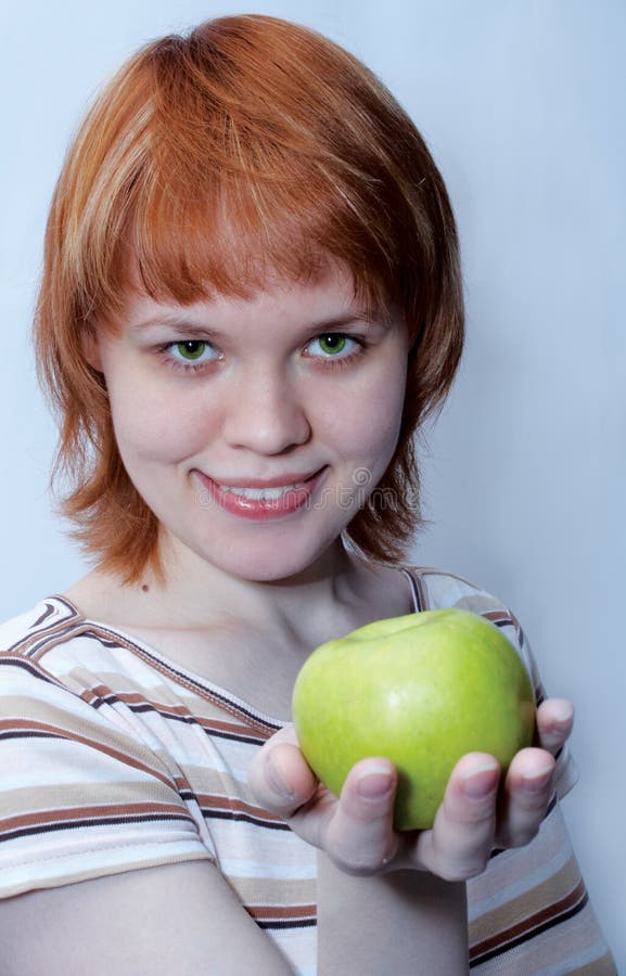 Red haired girl with green apple