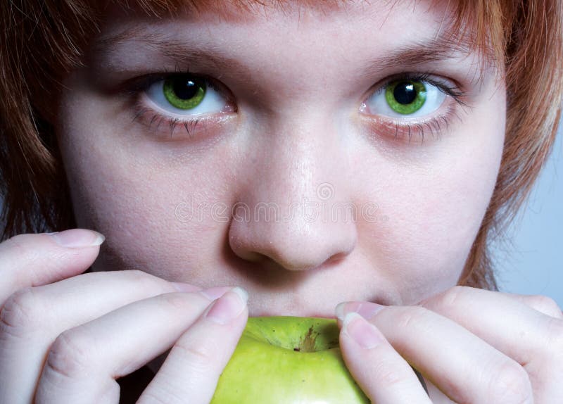 Red haired girl with green apple