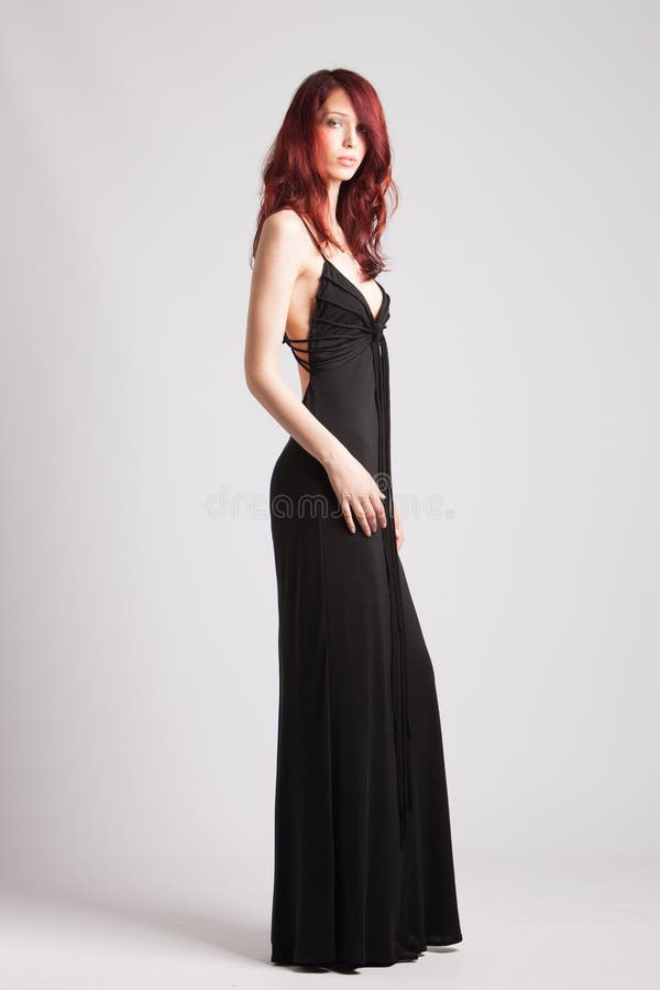 Red-haired girl in long evening black dress