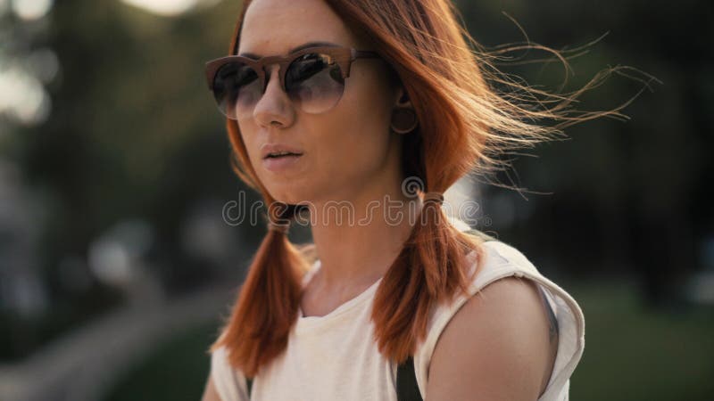 Red haired woman riding bicycle in city park on sunny day stock images Red haired woman riding bicycle in city park on sunny day stock images