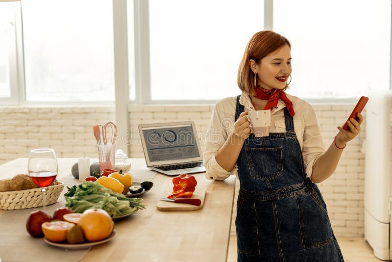 Red-haired young pretty girl with a red necktie looking amused royalty free stock photography Red-haired young pretty girl with a red necktie looking amused royalty free stock photography