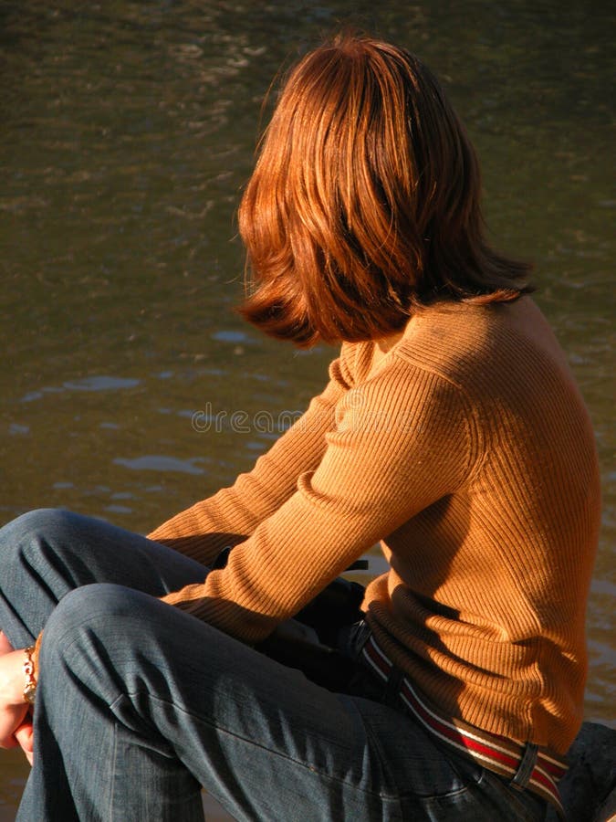 Red-headed girl by river