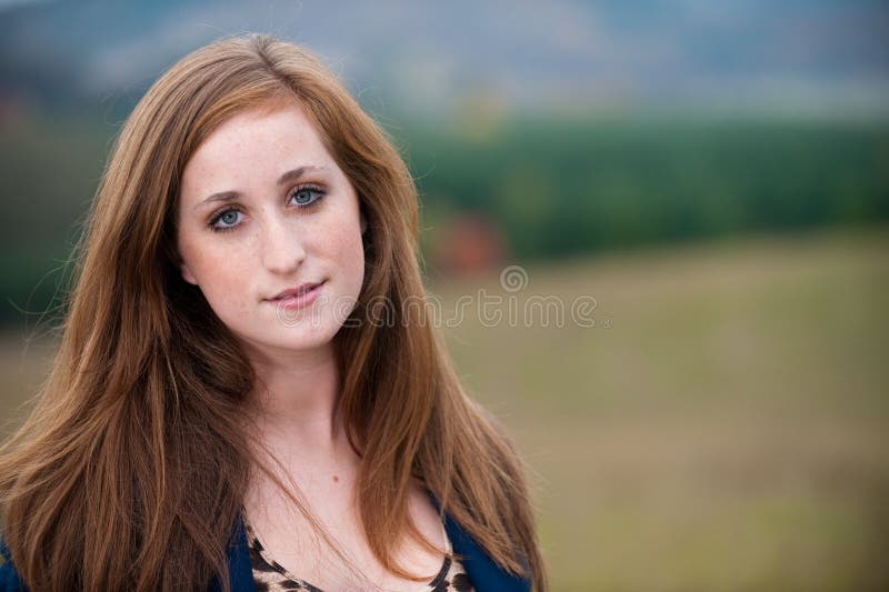 Red-headed teen girl outdoors