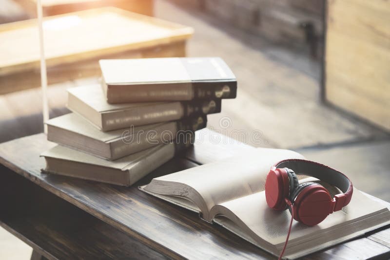 Red headphone on book in cafe or library.