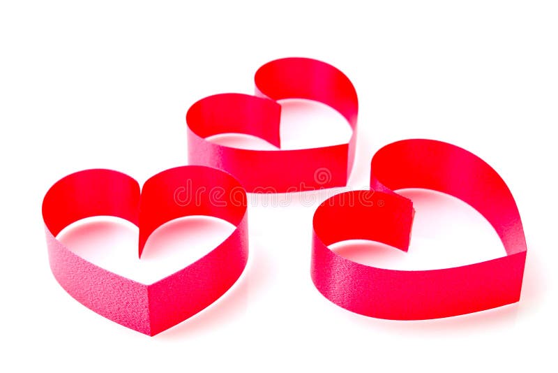 Red heart made from ribbon on white background