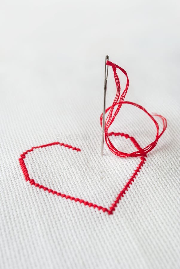 Red heart with needle