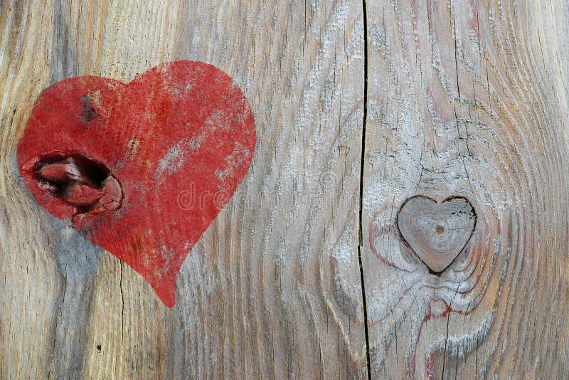 Red heart painted on wood and knothole in heart shape, love back